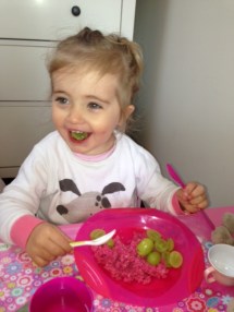 pink porridge with grapes - pink bowl green spoon